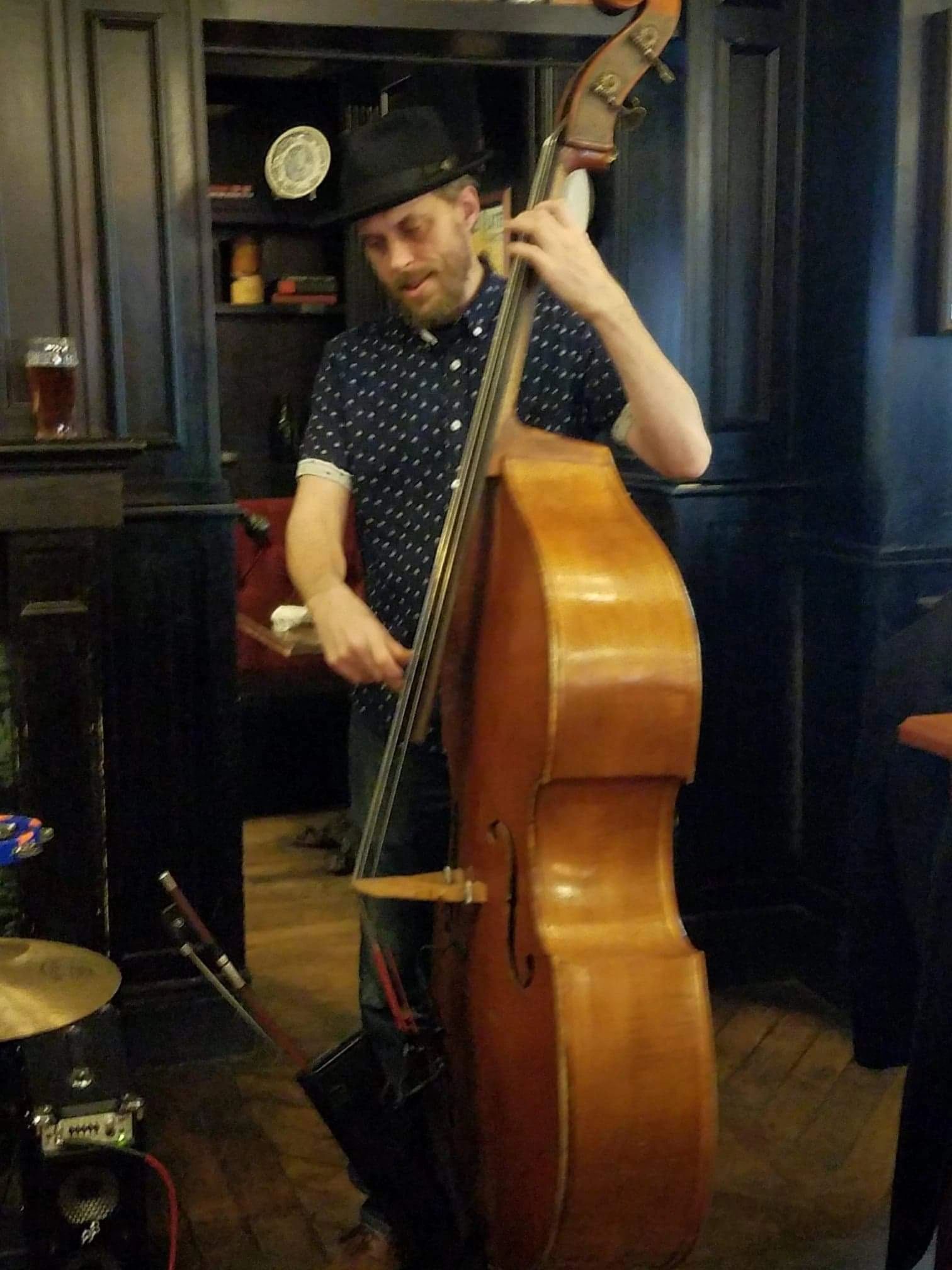 Matt Senjem playing upright bass at a pub gig